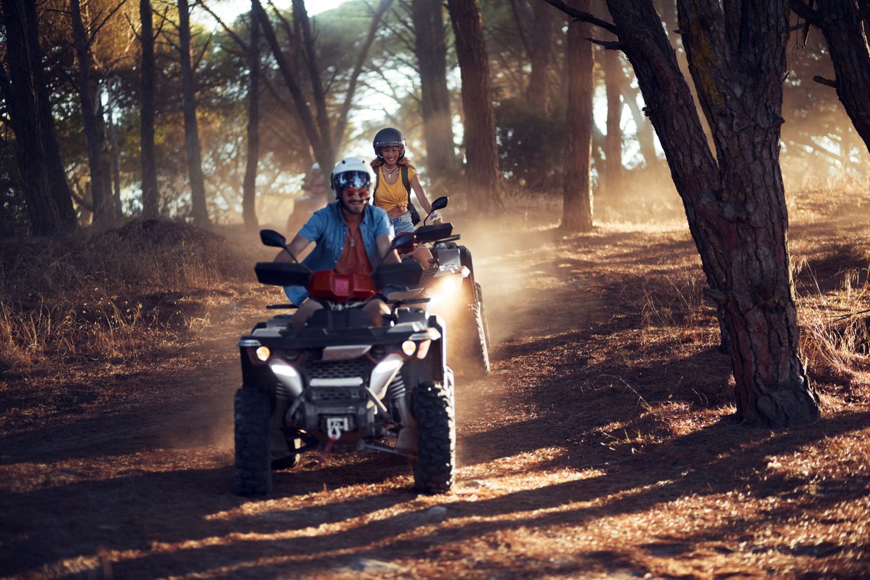People driving ATVs through the woods, highlighting Radiant Credit Union’s flexible loans for off-road vehicles and adventure gear.