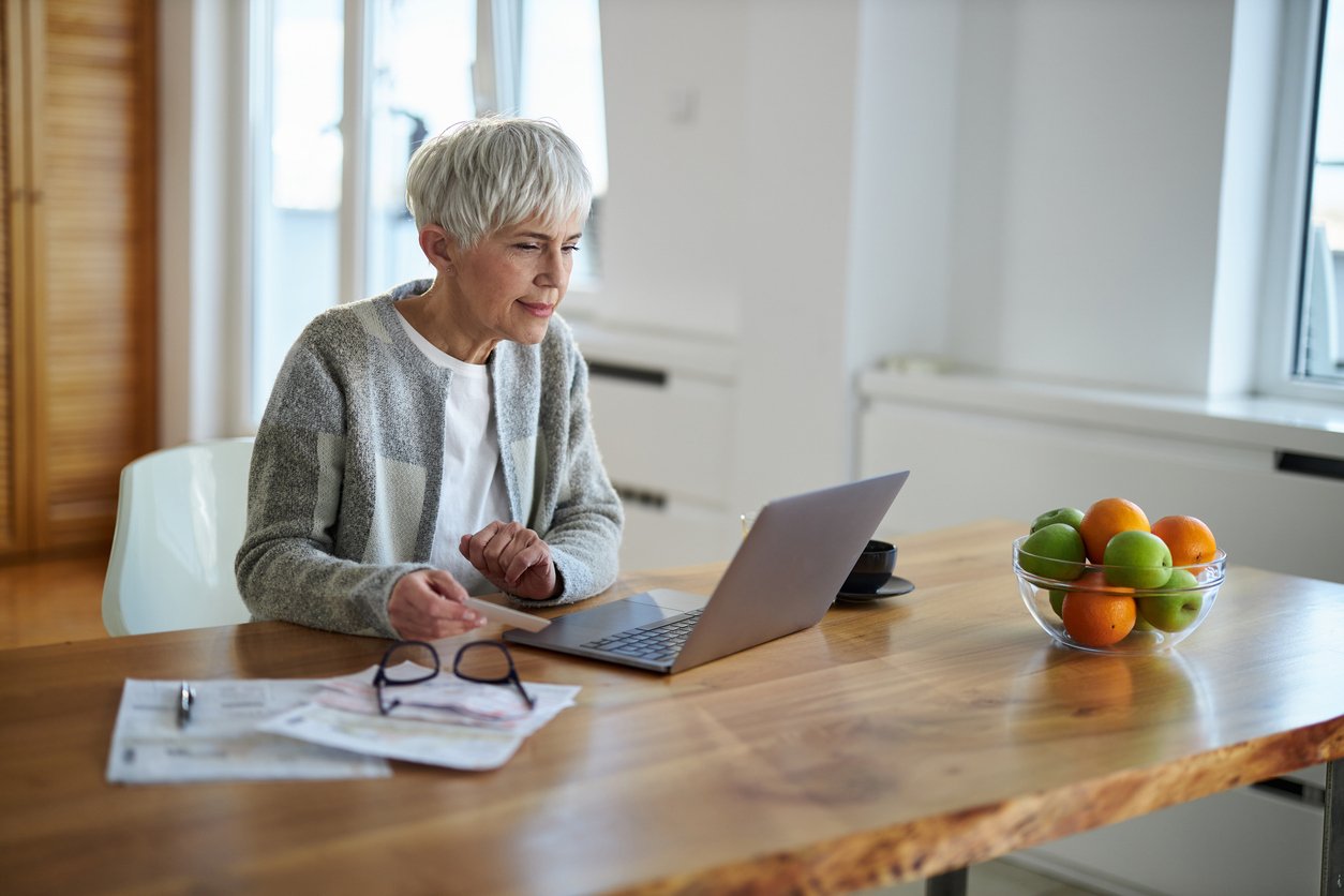 Woman managing her monthly expenses online using Radiant Credit Union bill payment services for easy, secure payments.