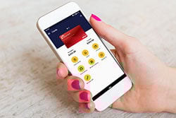 Woman using the Radiant Credit Union Card Manager app to control card settings and manage secure mobile banking.