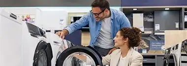 Couple Looking at Washing Machine