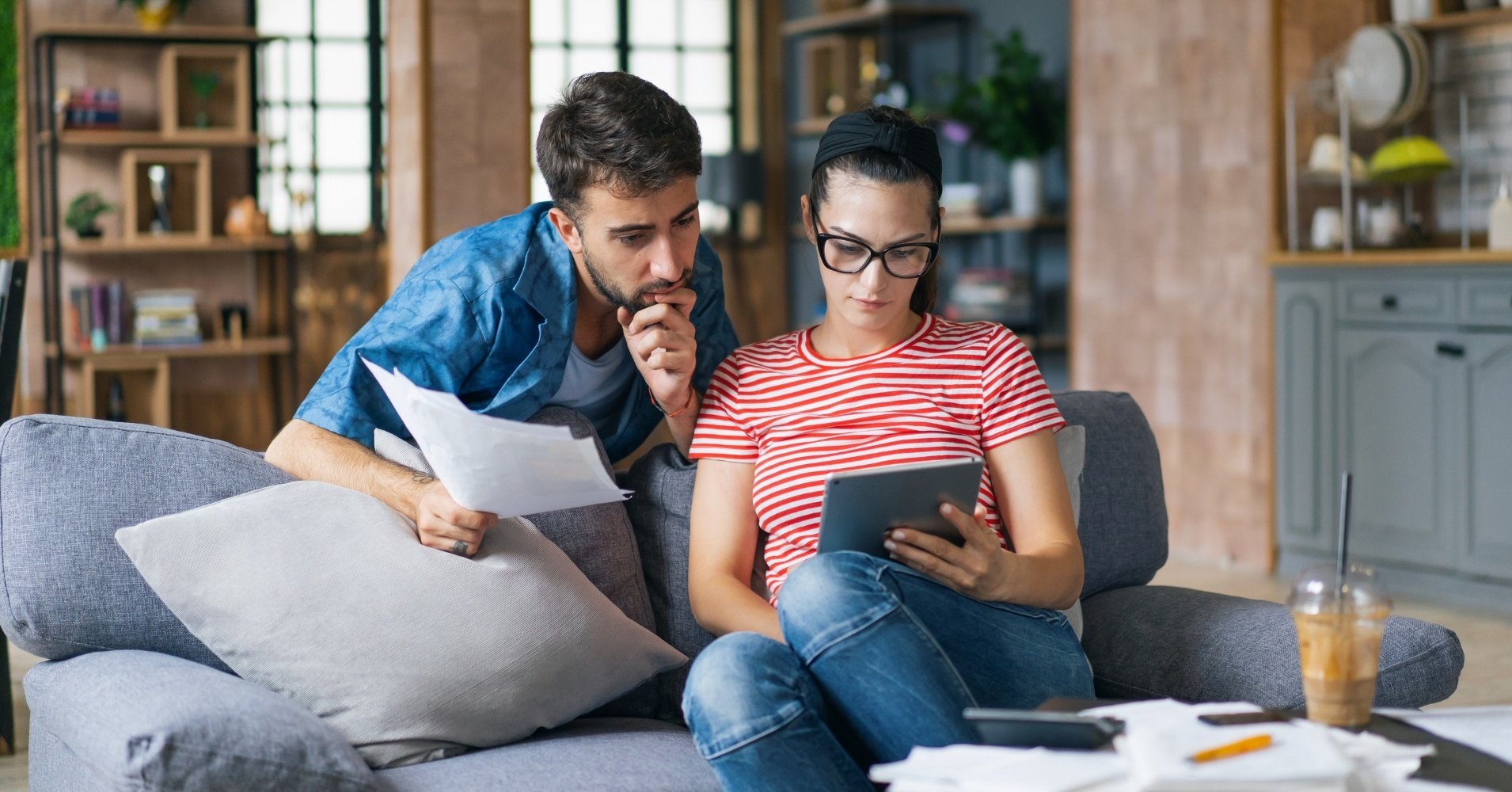 A couple reviews their Radiant Credit Union interest checking account online, earning dividends on every dollar to grow their money.