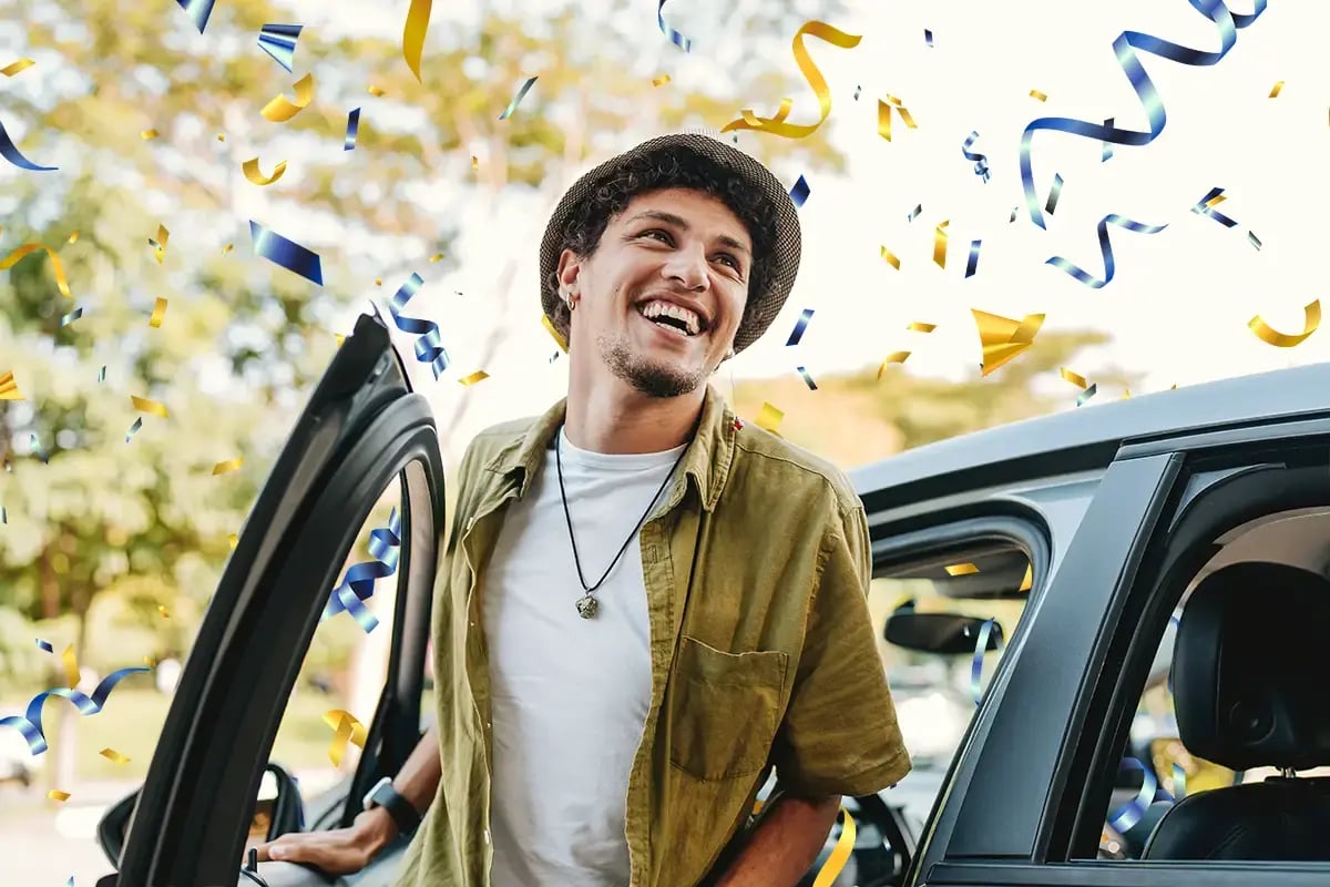 Man celebrating with confetti as he opens his car door. Man celebrating with confetti as he opens his car door.