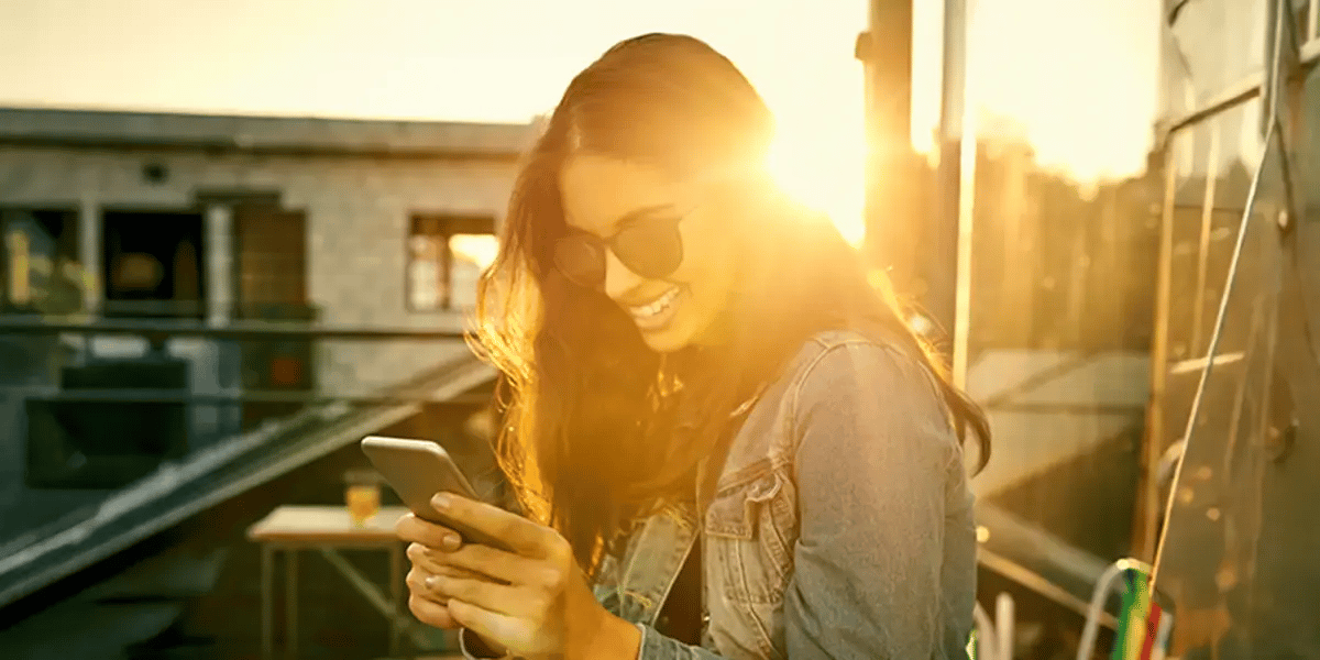 Woman is transferring funds to using ClickSWITCH on her phone.