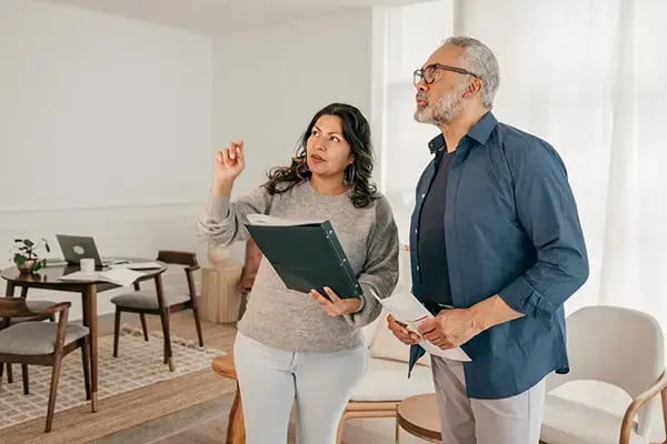 Couple reviewing details of a home before purchasing, carefully inspecting the space to prepare for their upcoming investment.