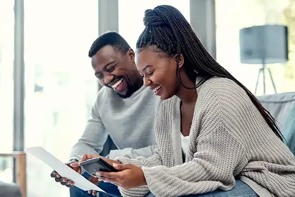 Couple reviewing refinancing contracts through Radiant Credit Union