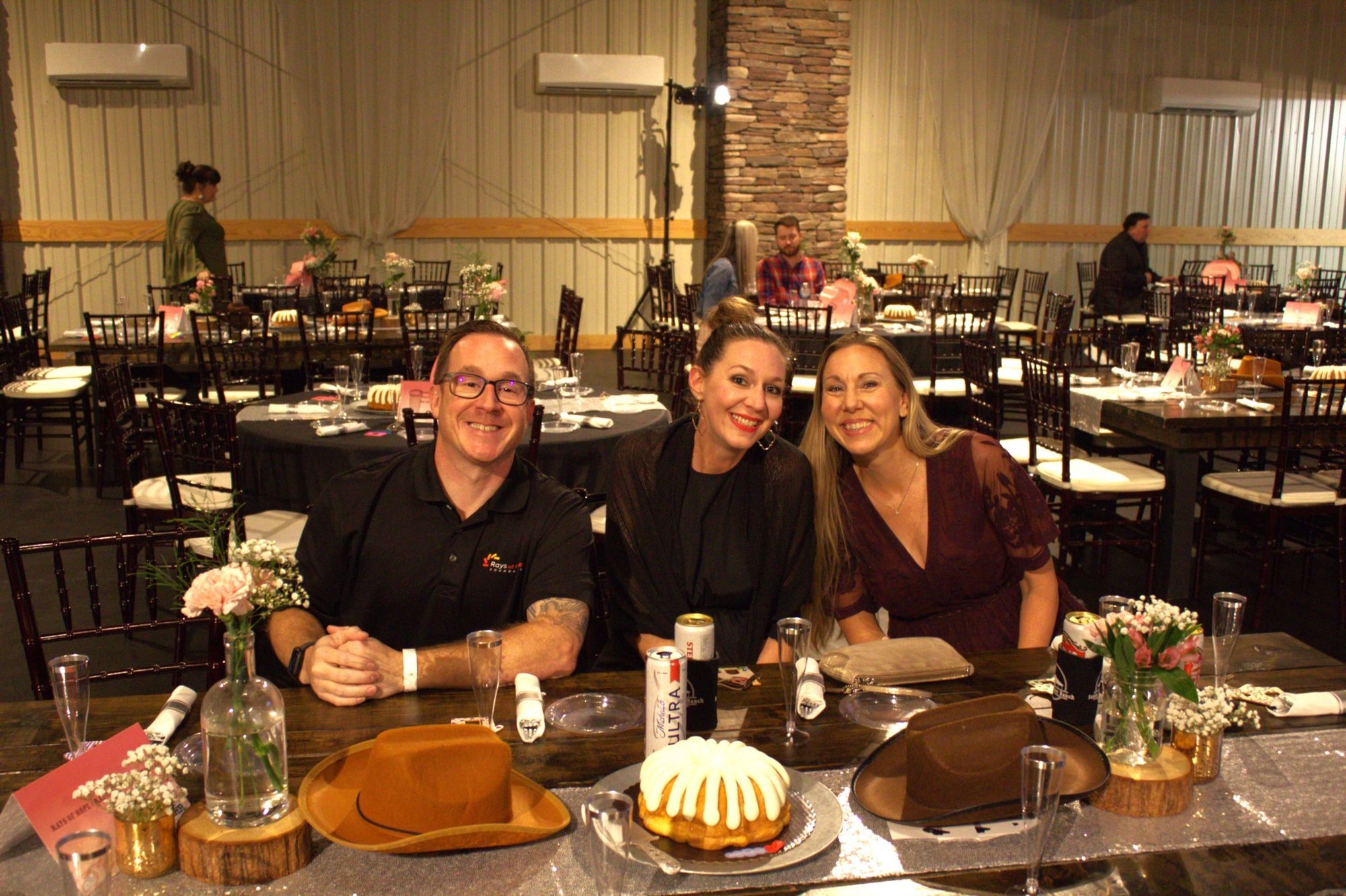 Smiling Radiant employees seated at dinner, helping raise funds for meaningful community causes.