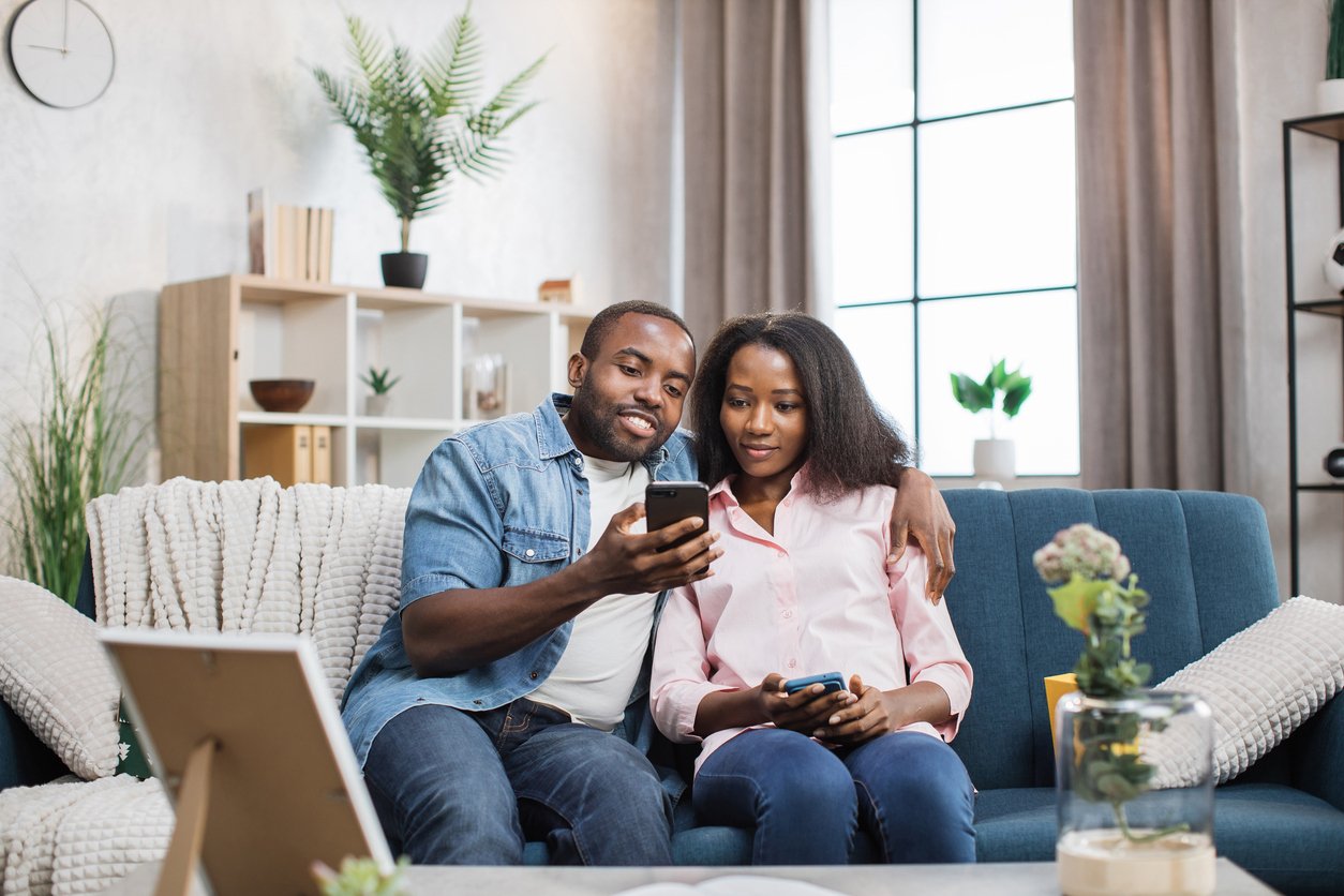 Smiling couple exploring Radiant Credit Union online investment options to build long-term financial security.