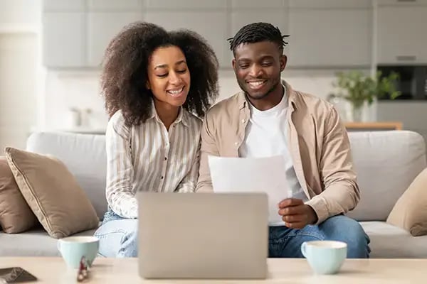 Smiling couple planning finances together as they explore a Radiant Credit Union line of credit for convenient borrowing options.