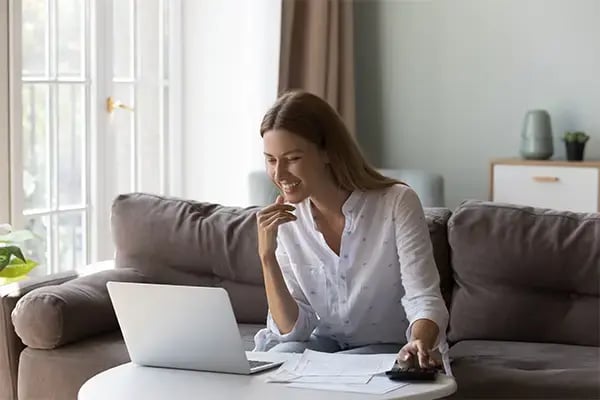 Woman at home using her computer to learn about secured loans from Radiant CU, looking for smart, secure borrowing solutions.