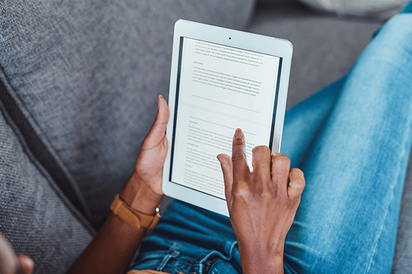 Hands holding a tablet while browsing a blog, symbolizing convenient access to tips, guides, and informative articles.