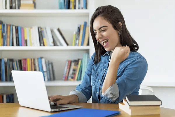 Excited woman using Radiant Credit Union Switch Cards to easily manage and update her subscription payments online.