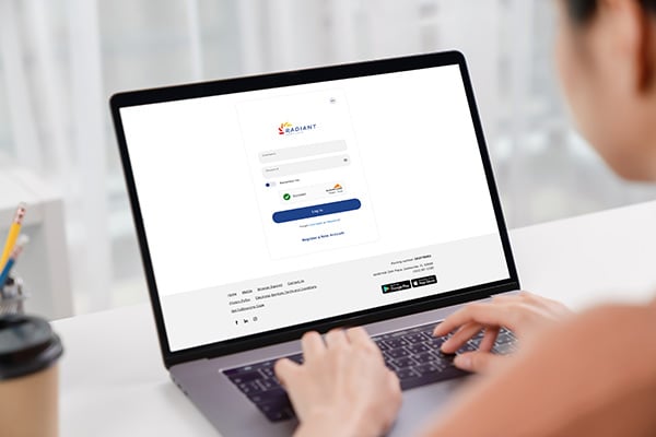 Person logging into Radiant Credit Union’s website to access secure eBanking features and manage accounts online.