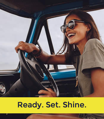 woman driving and smiling