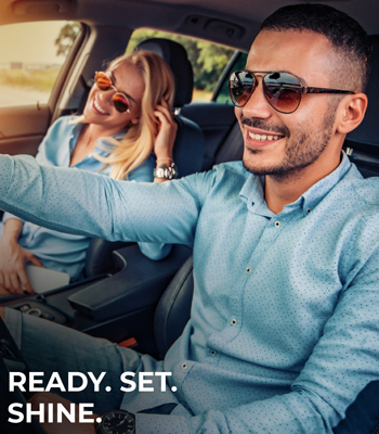 man and woman driving and smiling