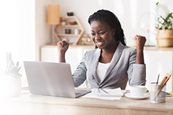 Woman excited at computer