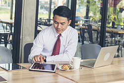 business man on laptop and tablet