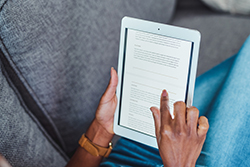 person looking at a blog on a tablet