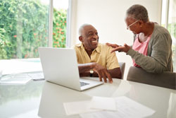 many and women talking at laptop