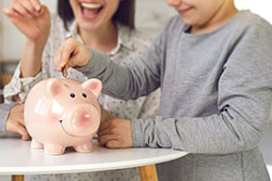 mom and kid with a piggy bank