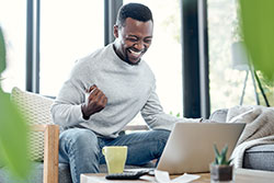 an excited man at computer