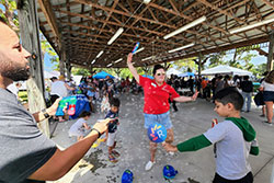 employees blowing bubbles with kids