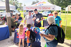 employees talking with children at event