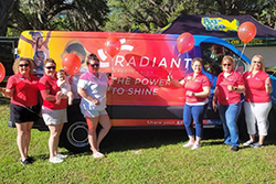 Radiant employees in front of Radiant Van