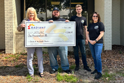 Radiant employee presenting check to ARC