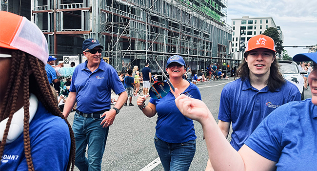 employees walking in homecoming parade